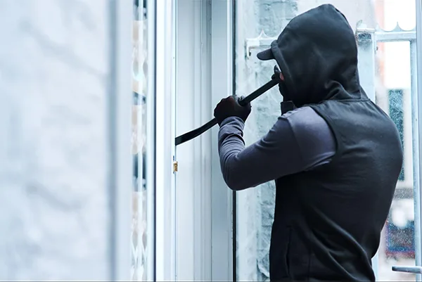 A burglar trying to break into a home