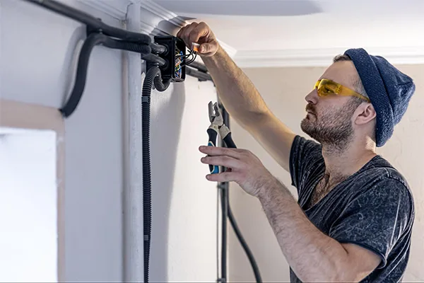 An electrician setting up a camera
